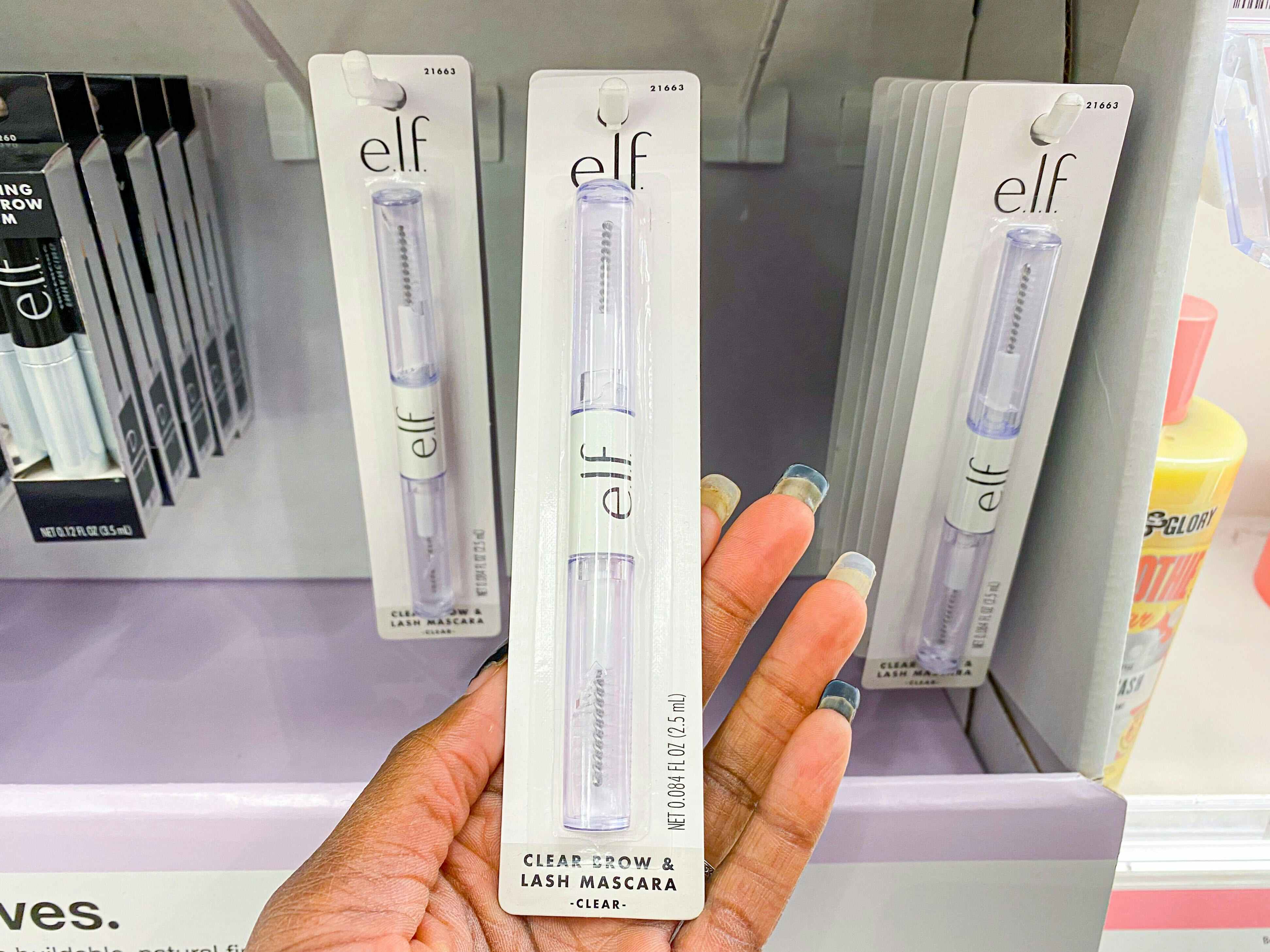 hand holding elf mascara out in target store