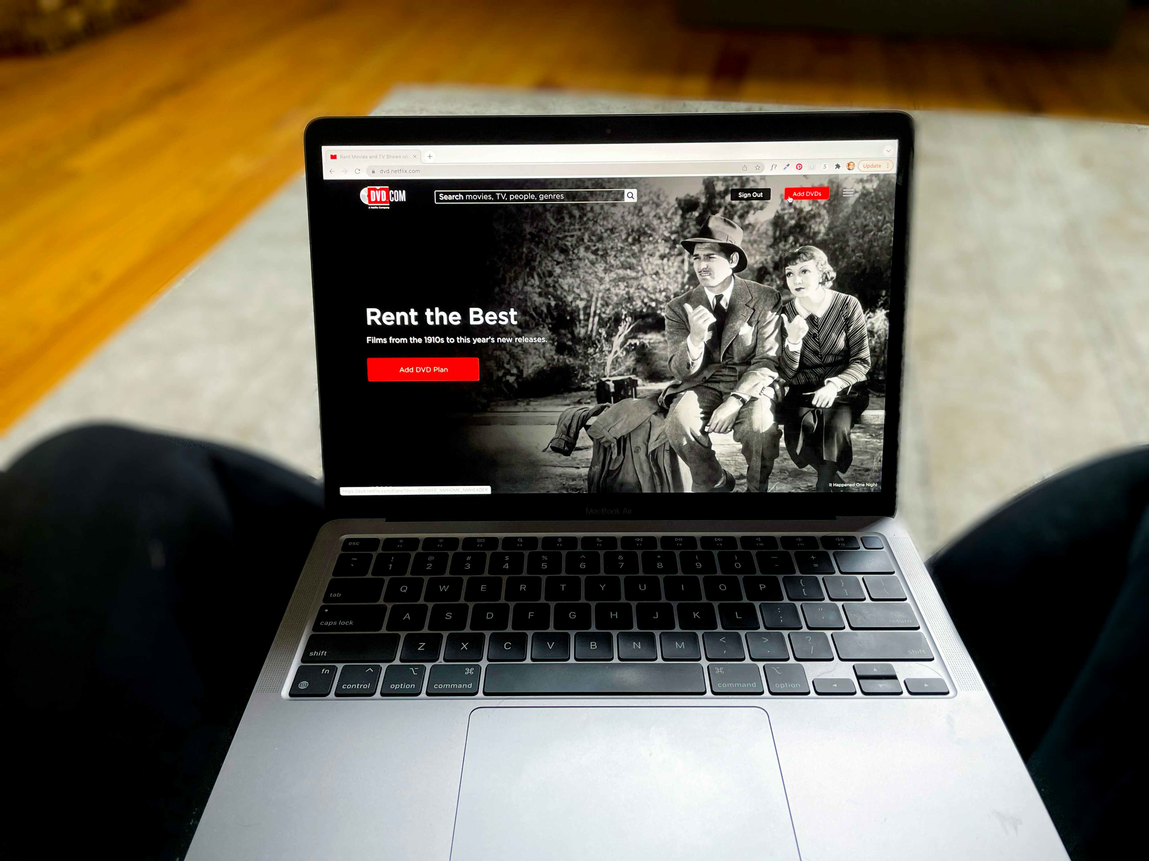 Laptop screen showing Netflix's DVD rental service homepage