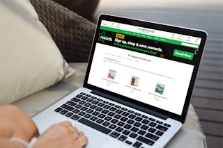 A woman on her laptop looking at the Pet Supplies Plus rewards program page on their website