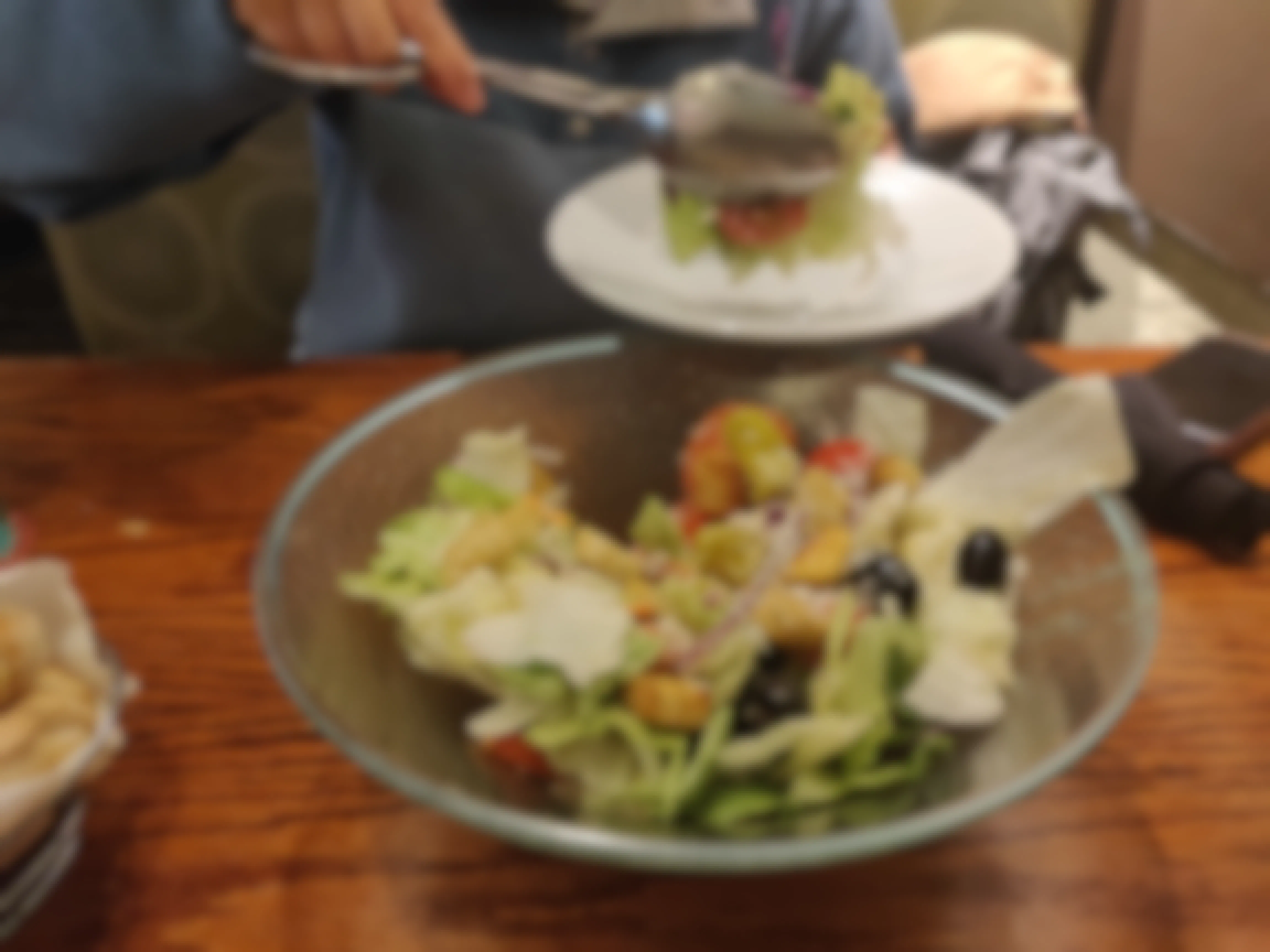 woman putting salad on her plate at olive garden