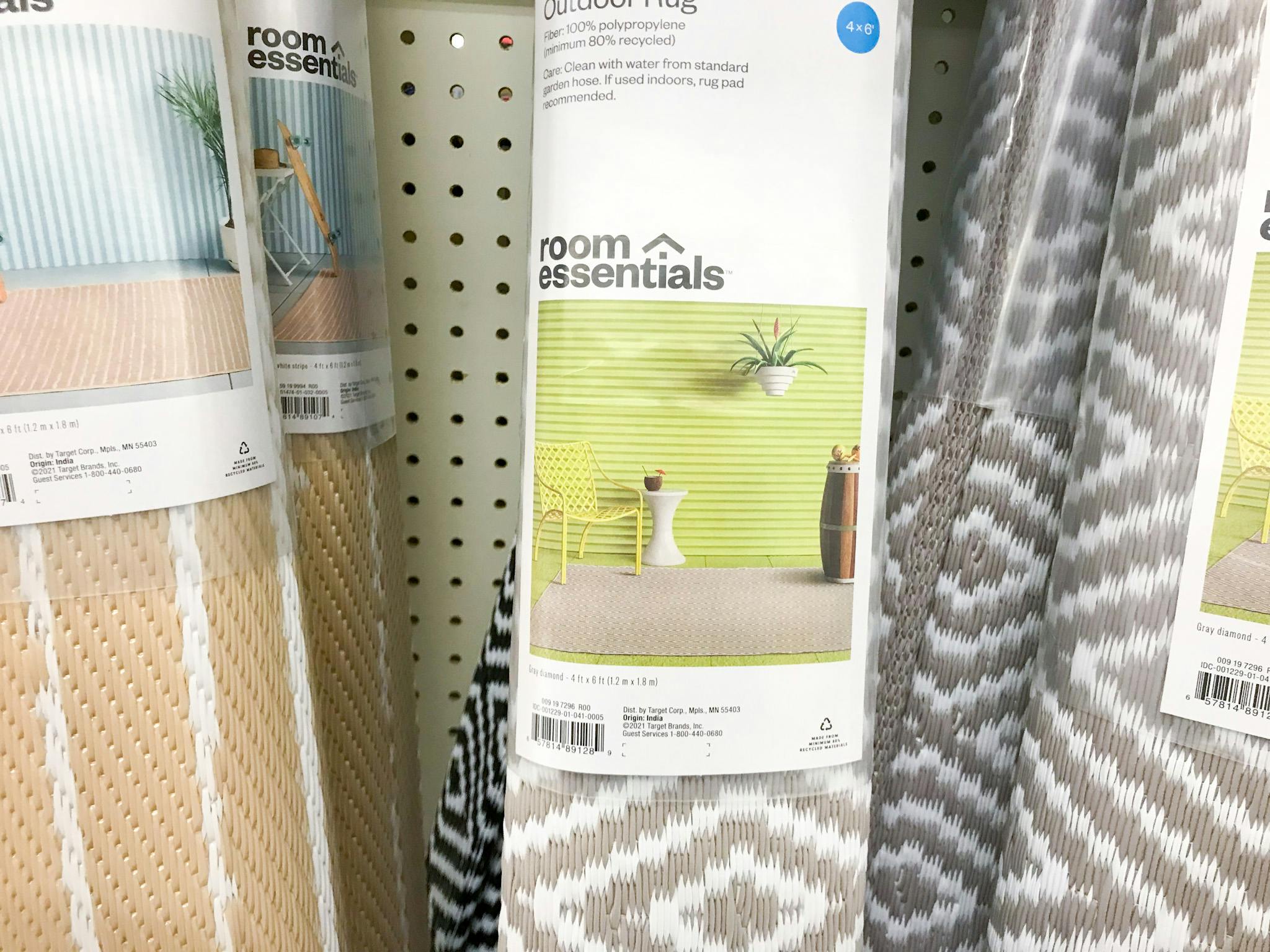 A close up on a Room Essentials outdoor rug in a roll on a shelf at Target