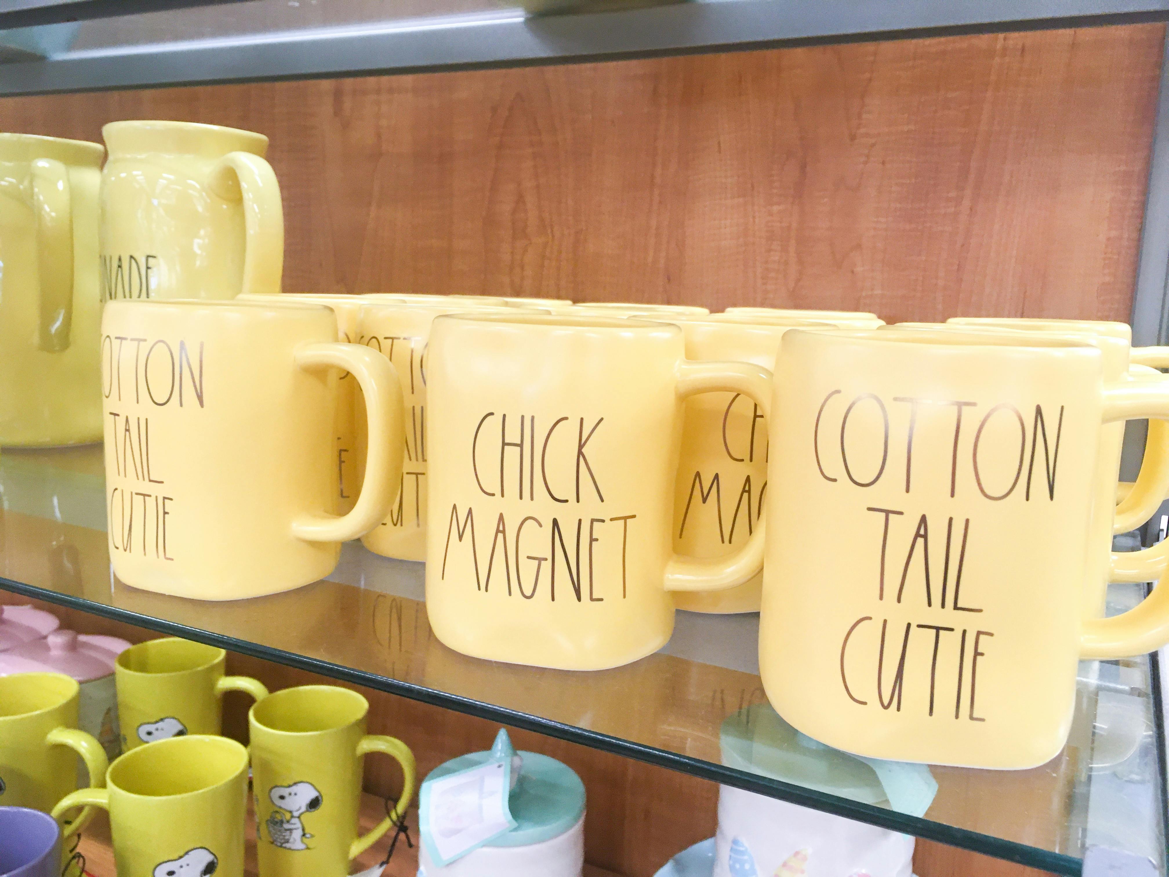 Easter themed Rae Dunn mugs on a shelf in TJ Maxx.
