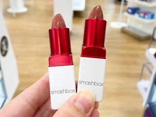 person holding two smashbox prime plush lipsticks in ulta store