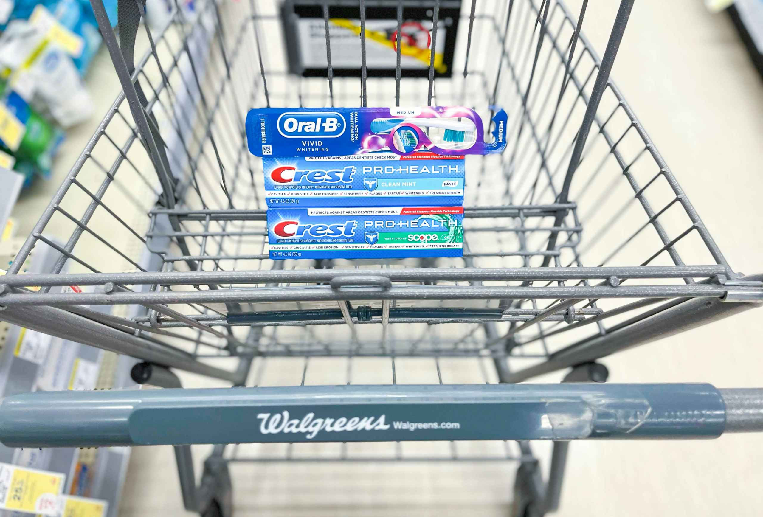 shopping cart with two tubes of Crest toothpaste and an Oral-B toothbrush
