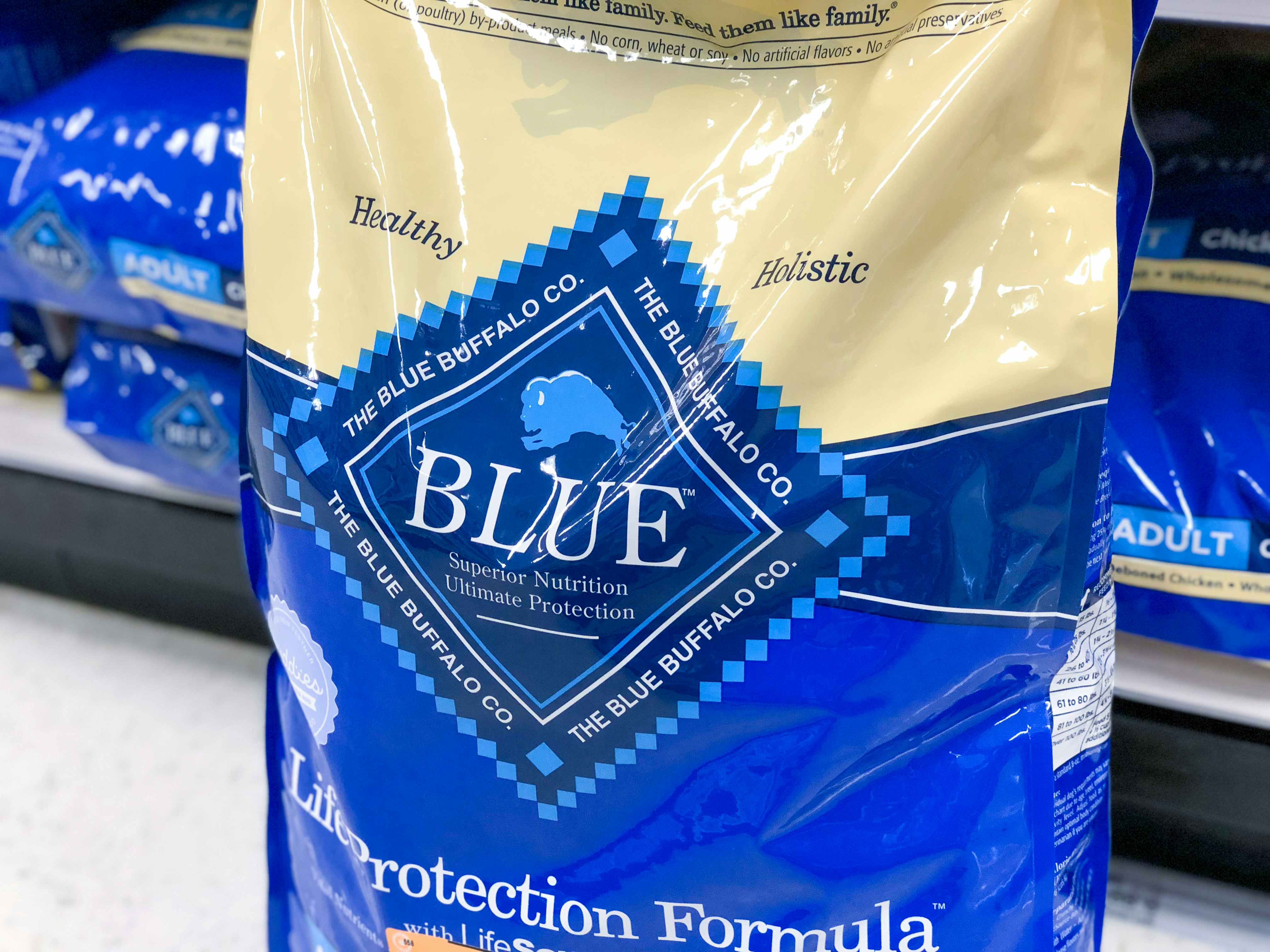 A bag of Blue Buffalo dog food in a store aisle.