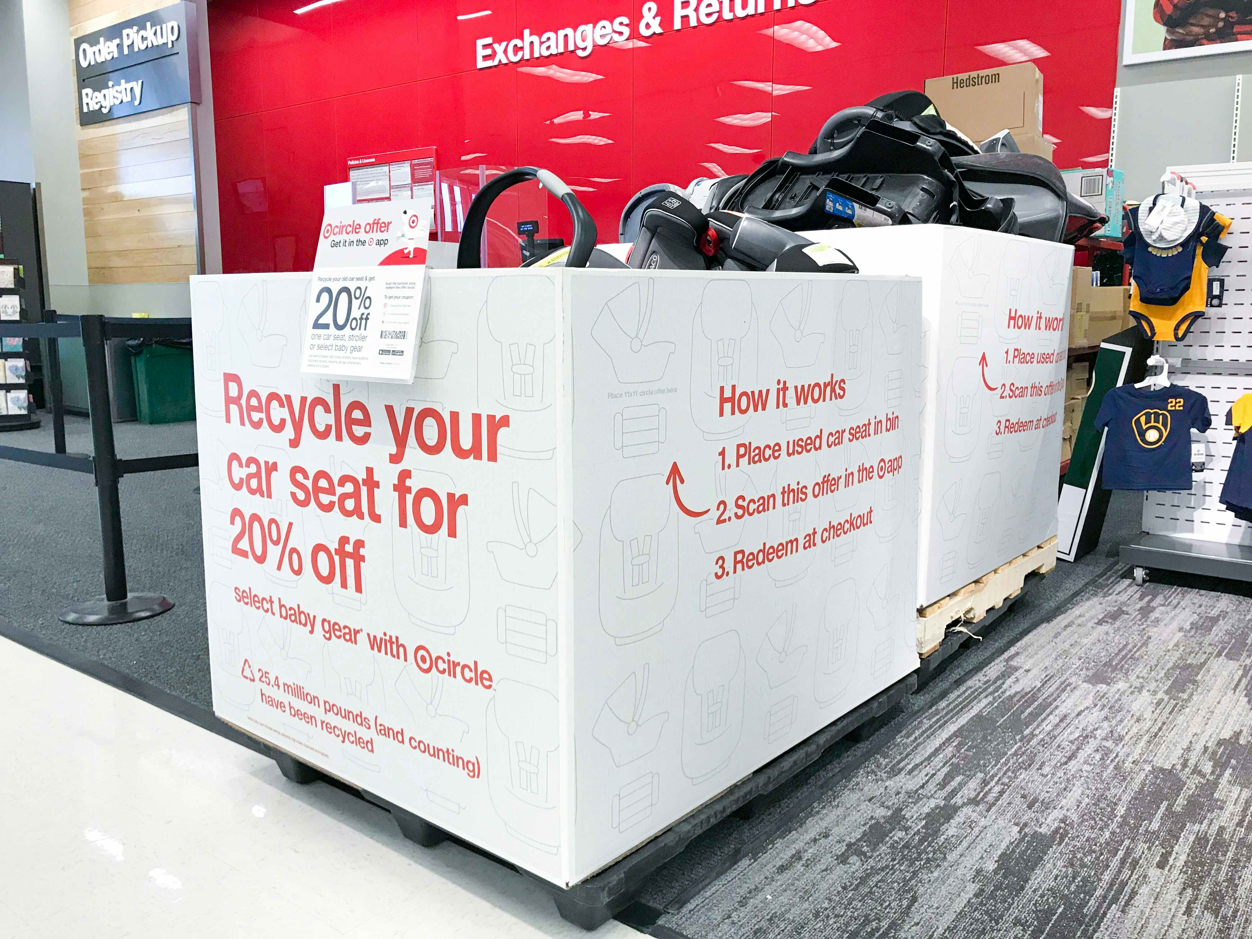Two large boxes on a pallet inside Target, filled with old carseats to be recycled.