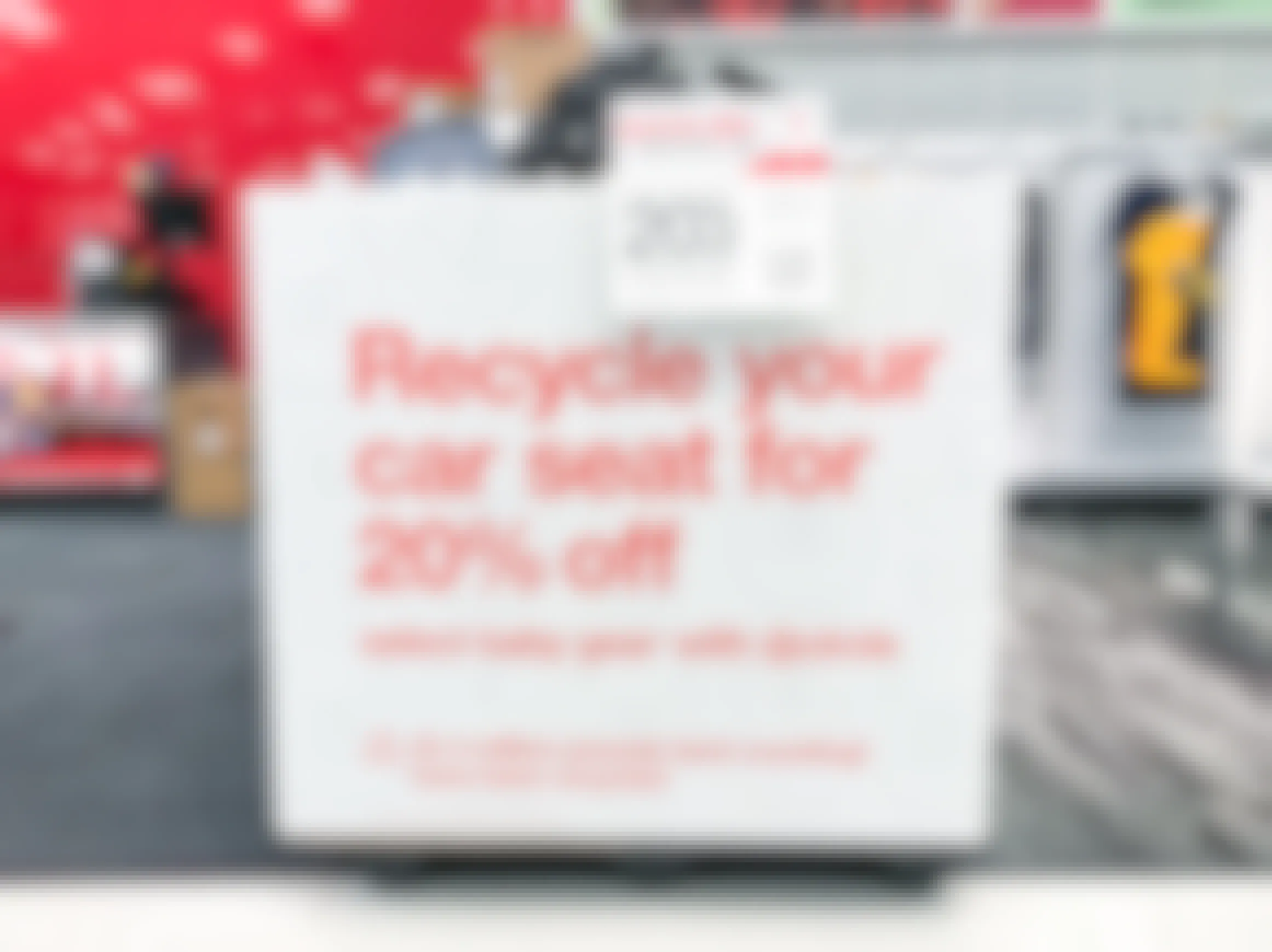A sign inside Target advertising 20% off select baby gear when you recycle a car seat.