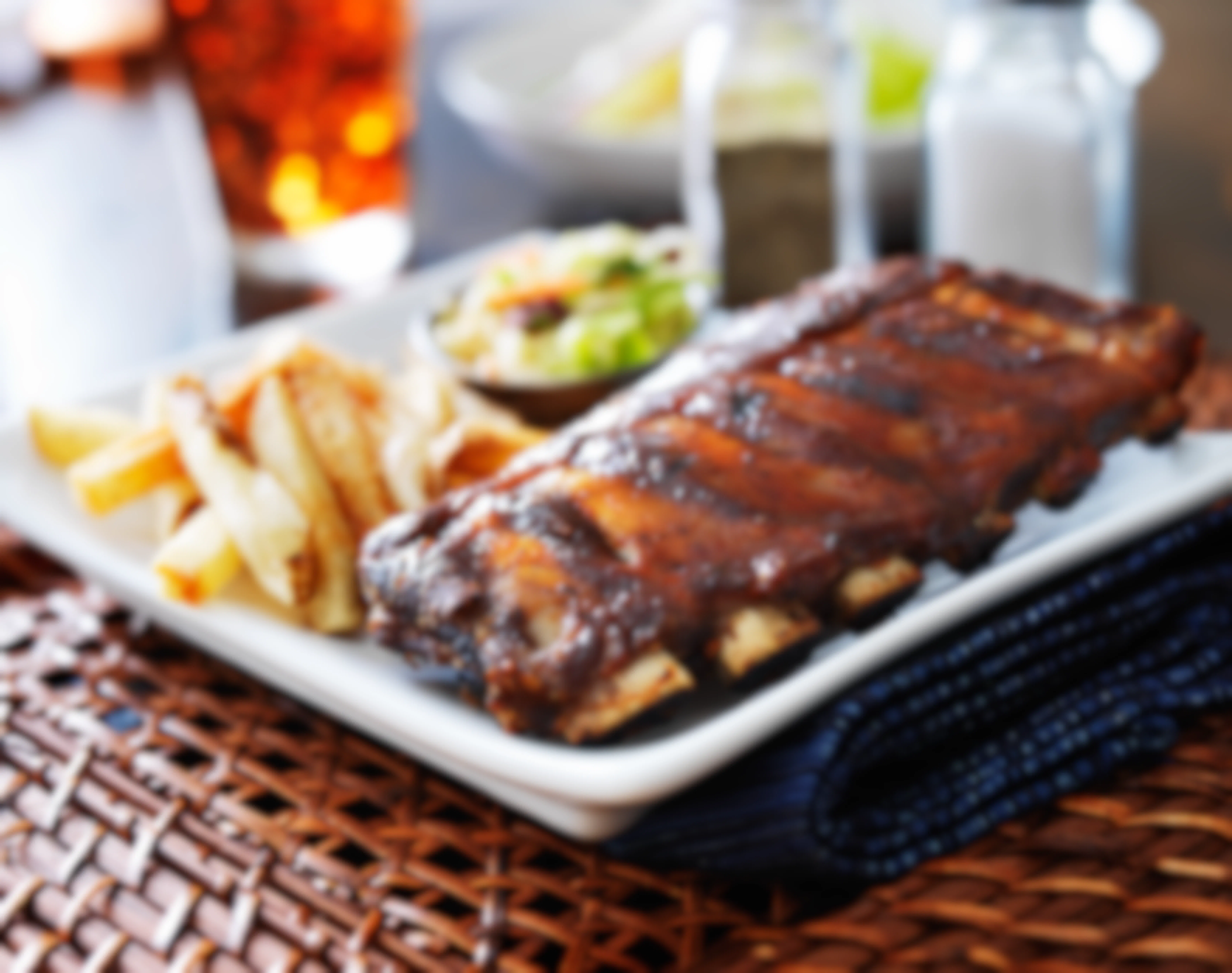 Barbecue ribs on a plate with fries.