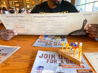 person holding menu at cracker barrel restaurant table