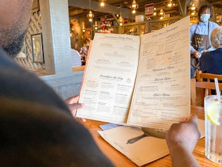 a person looking at a menu at cracker barrel
