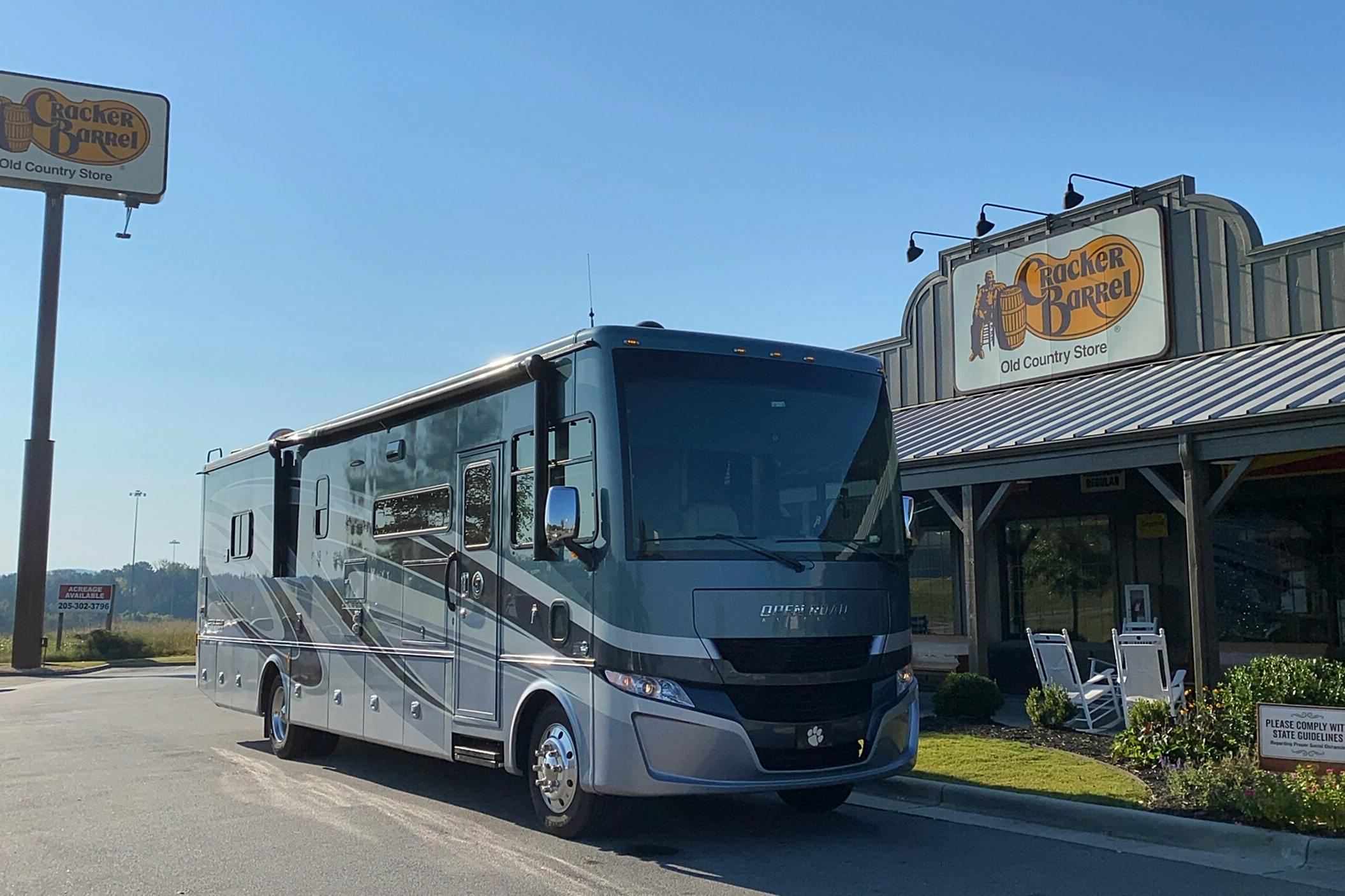 An RV parked in front of a Cracker Barrel restaurant