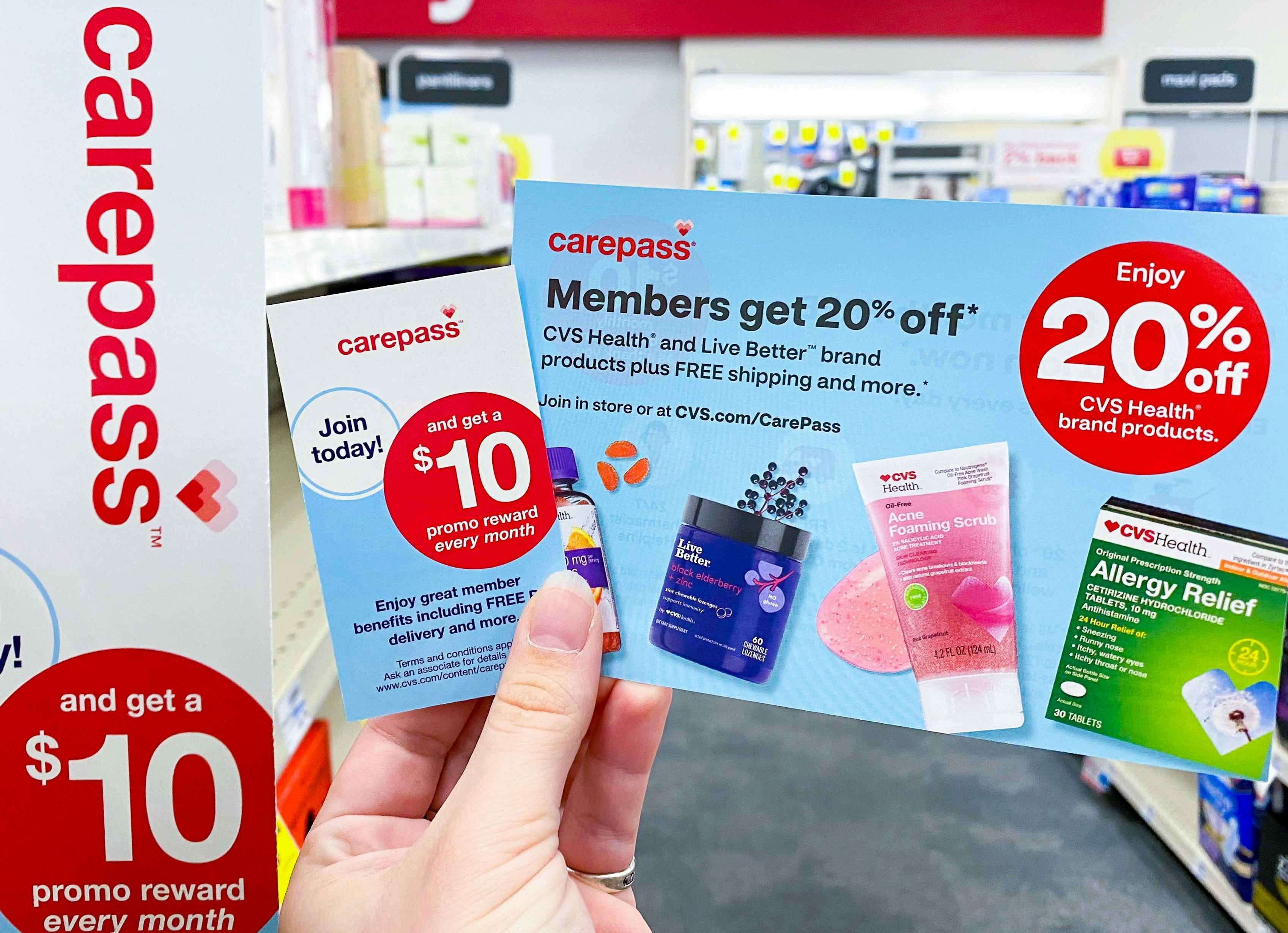 Someone holding some CVS Carepass information cards in a CVS