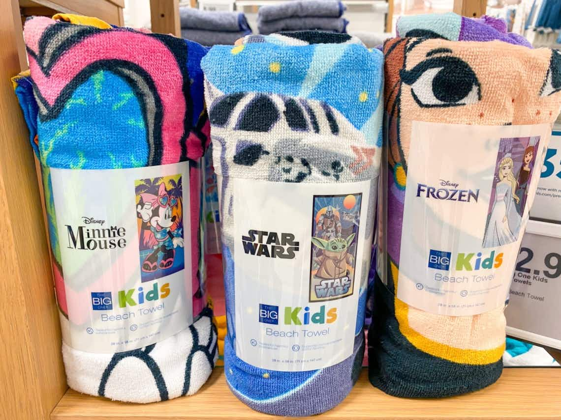 disney beach towels on shelf