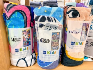 disney beach towels on shelf