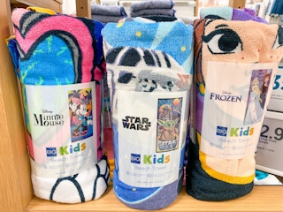 disney beach towels on shelf