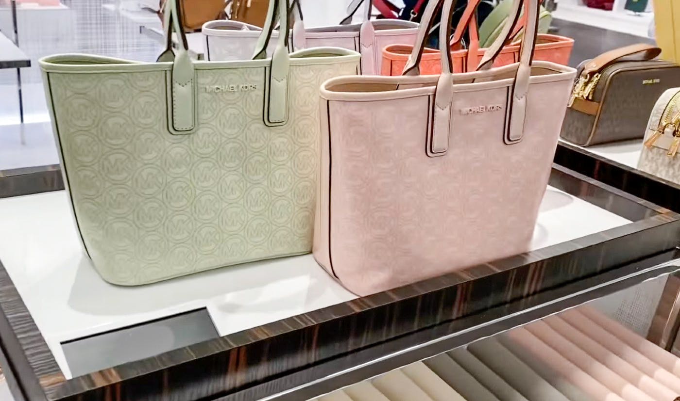 michael kors handbags on a display shelf.