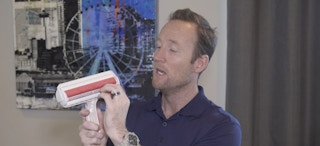 Man holding the Chom Chom pet hair remover device.