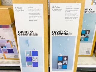 Two boxes for Room Essentials 6-Cube Organizers on the floor in front of the shelf at Target.