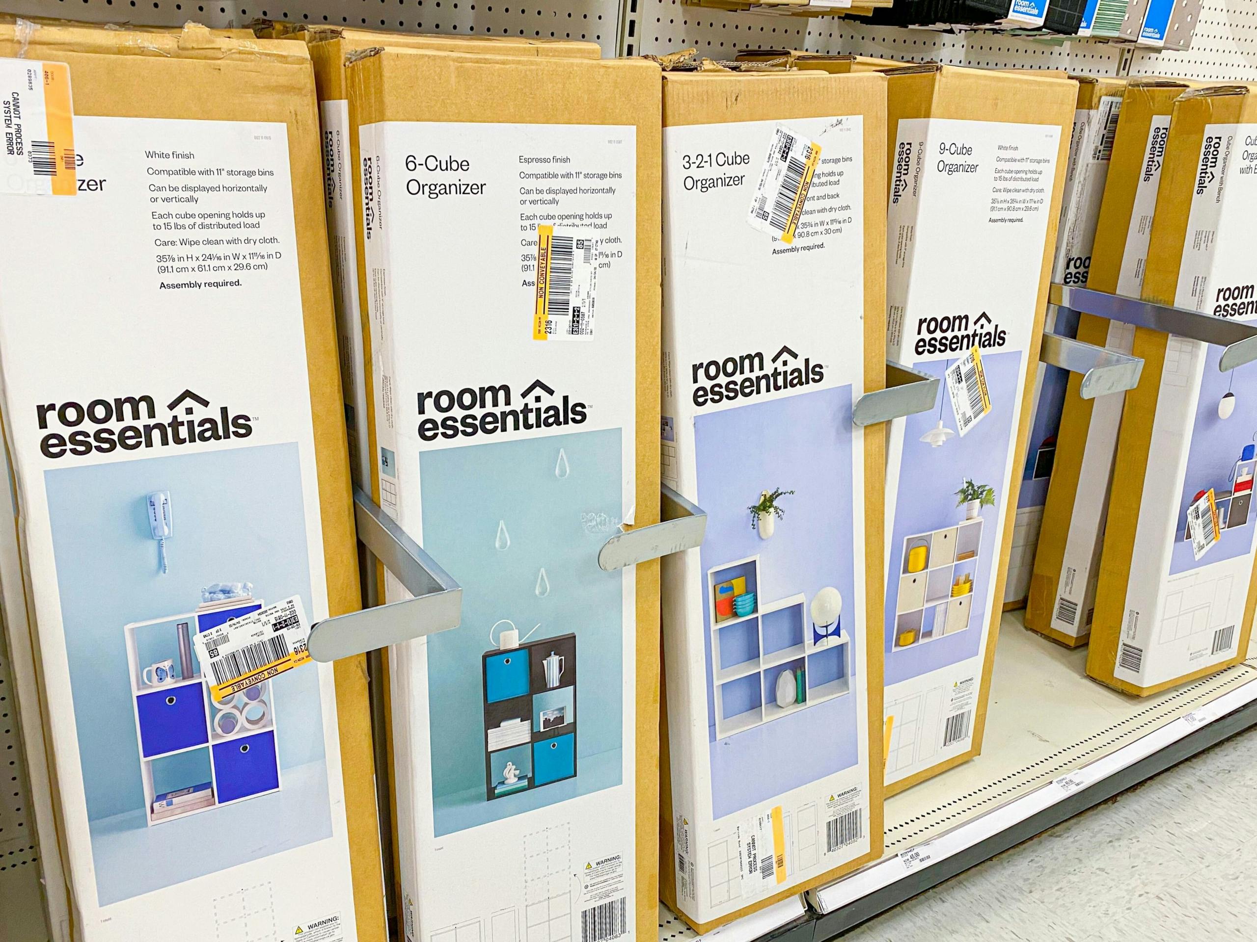 A shelf of boxes for different Room Essentials cube organizers at Target.