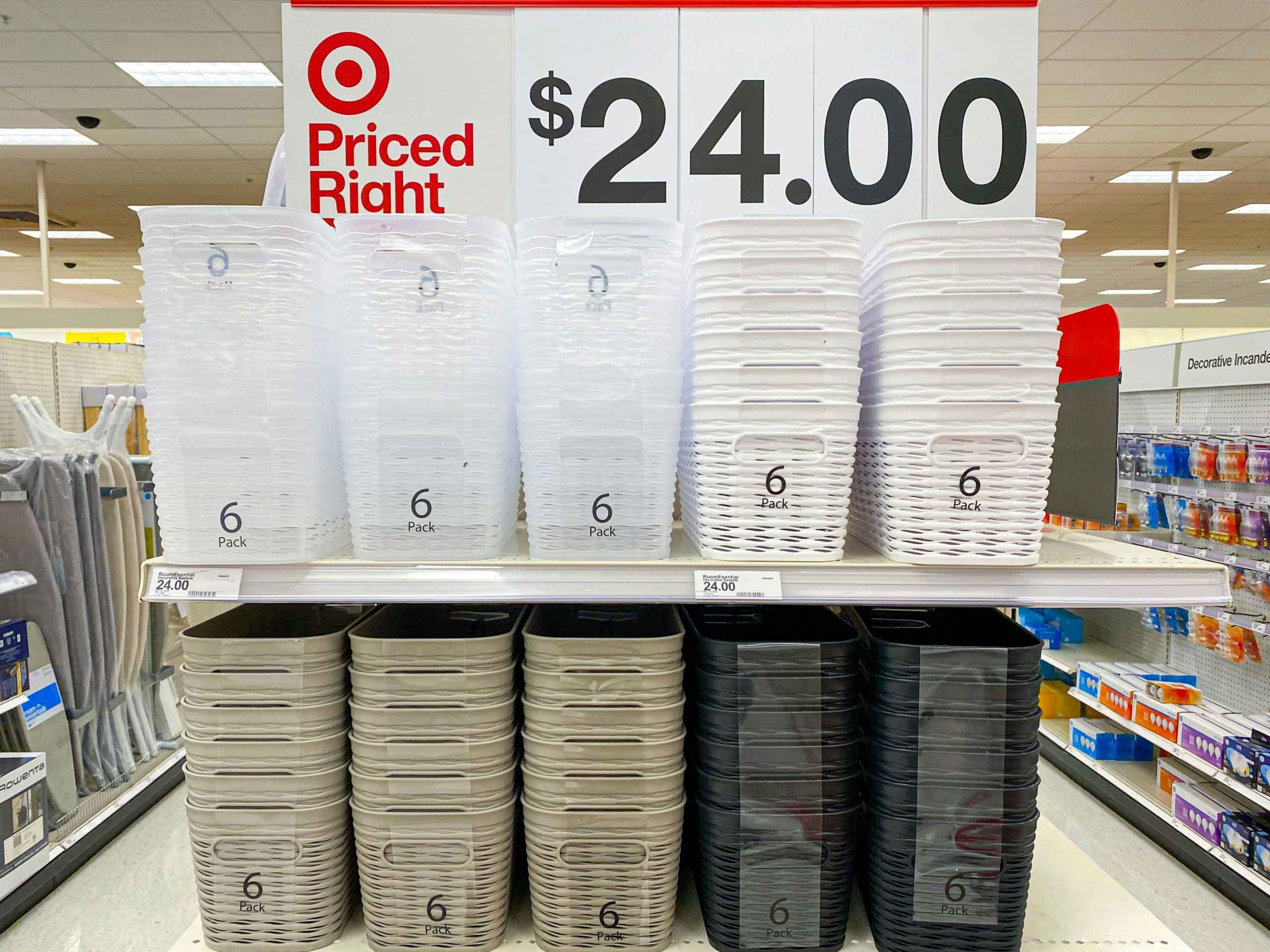 An end-cap shelf at Target displaying 6-packs of storage bins in different colors, advertised as $24.00 above the shelf.
