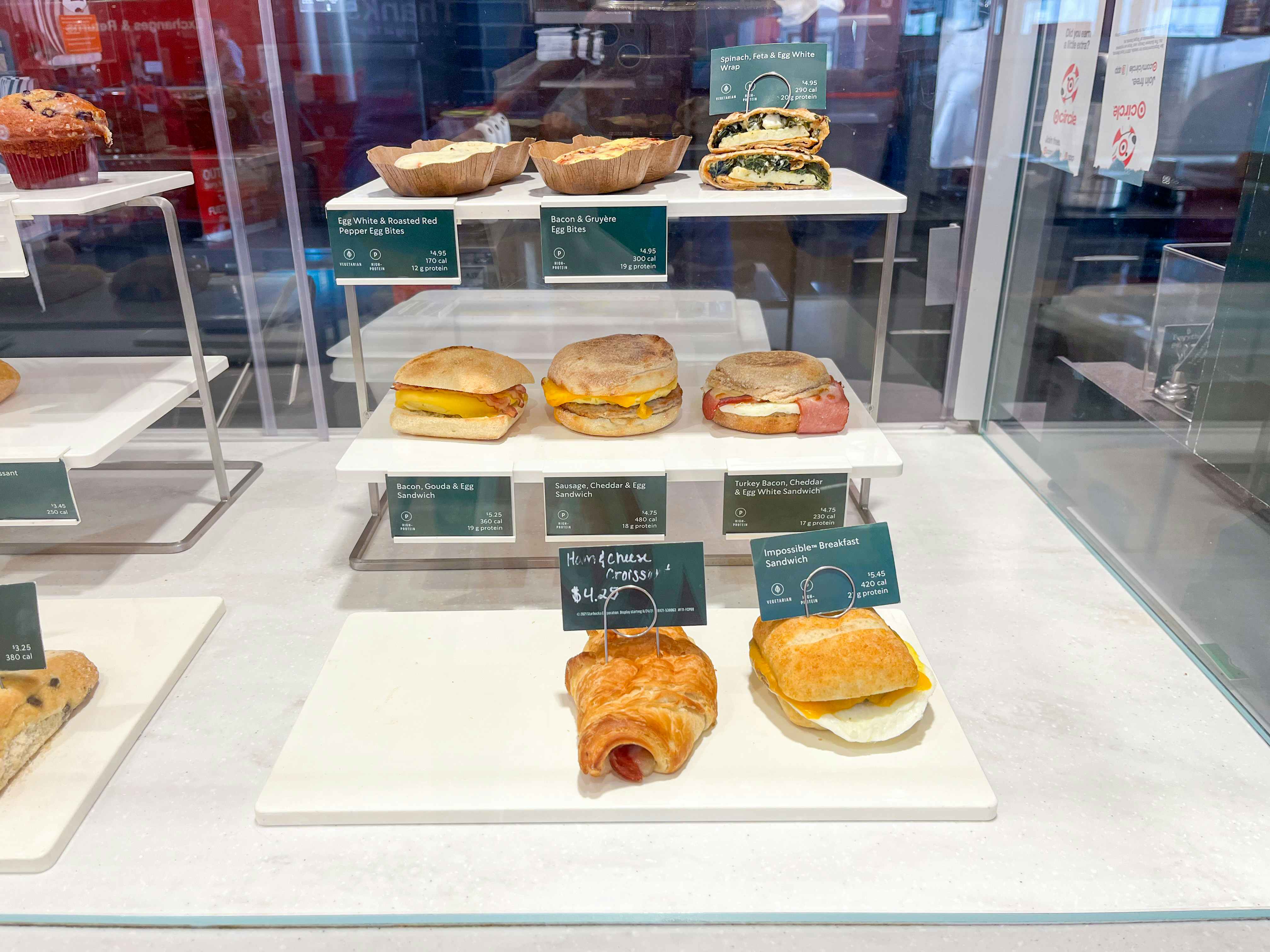 The enclosed sandwich display at a Starbucks counter featuring the different savory foods you can order.