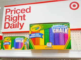 Boxes of 48 count Crayola Washable Sidewalk Chalk stocked on an endcap shelf at Target, in front of a sign that says, "Priced Right Daily