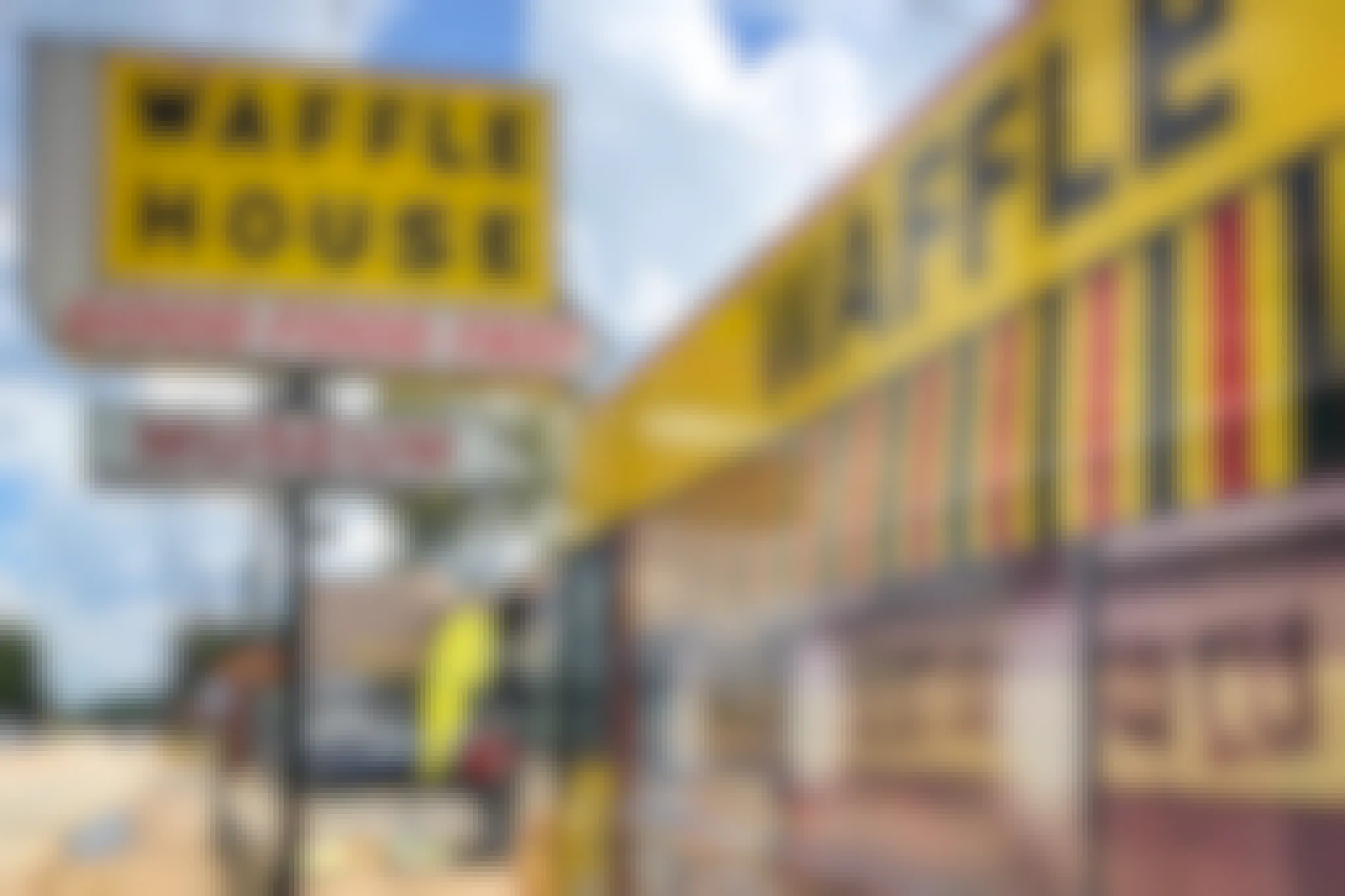 A sign for the Waffle House Museum outside of a Waffle House storefront.