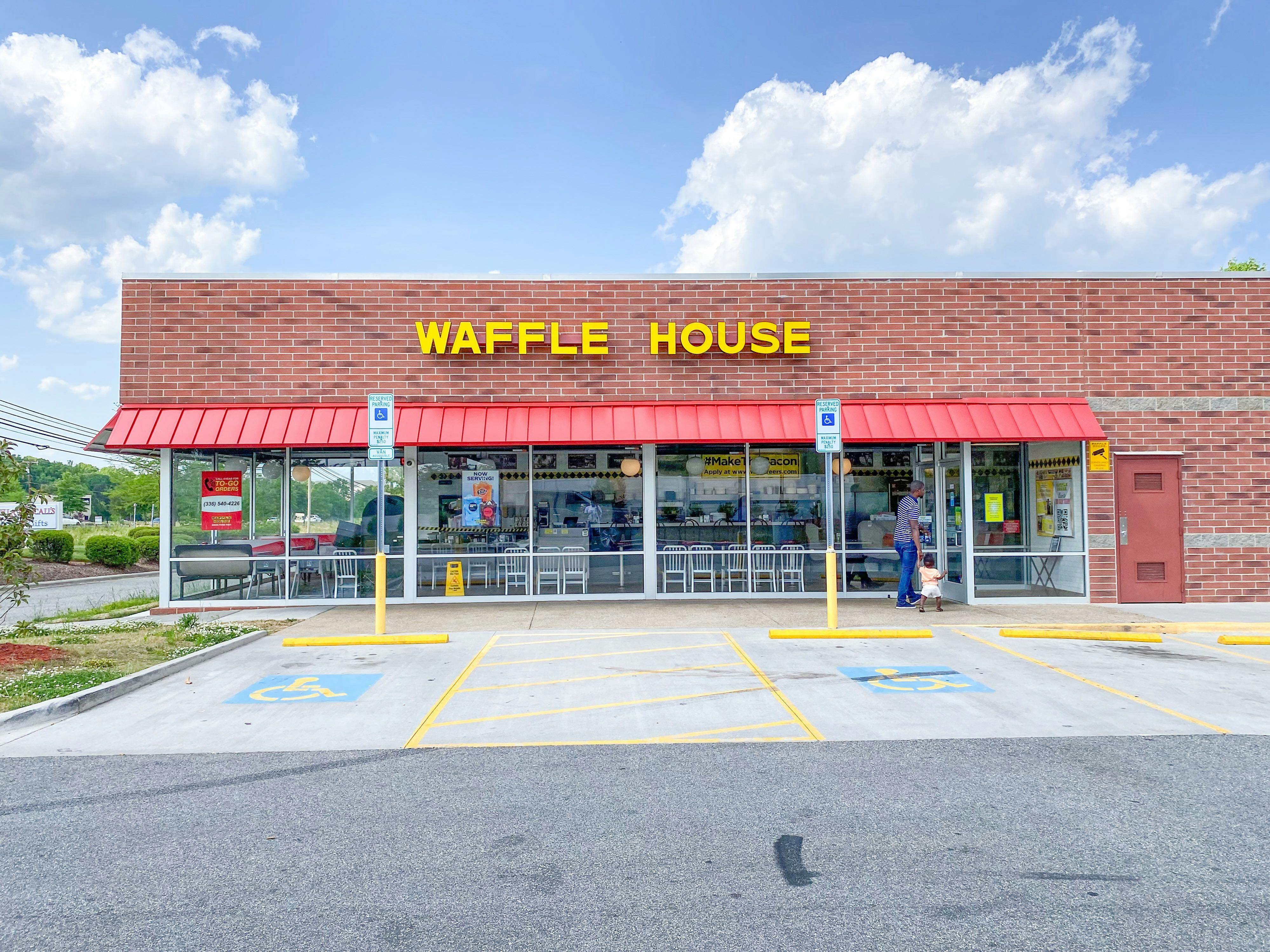 A Waffle House storefront from the parking lot.