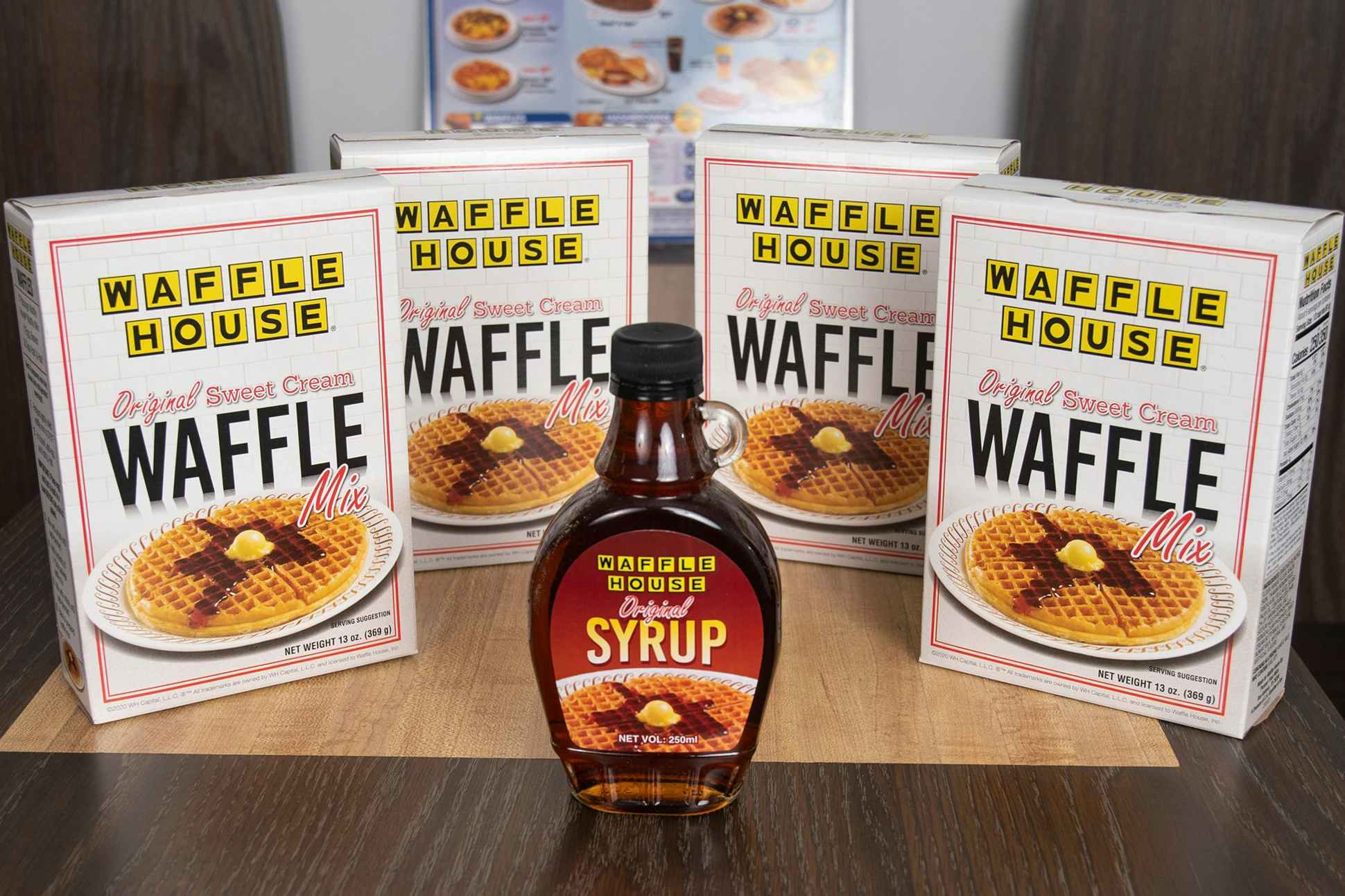 4 boxes of waffle mix and maple syrup on a table at the Waffle House