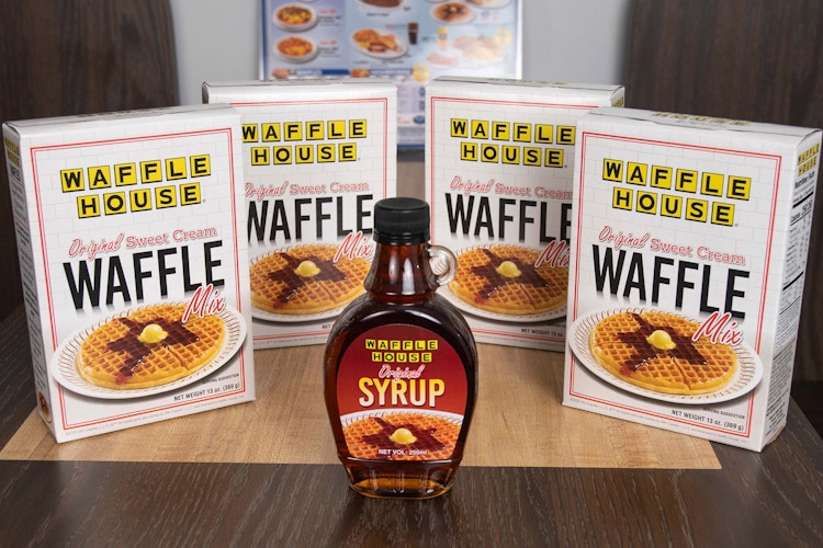 4 boxes of waffle mix and maple syrup on a table at the Waffle House
