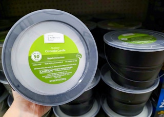 hand holding mainstays citronella candle bucket at walmart