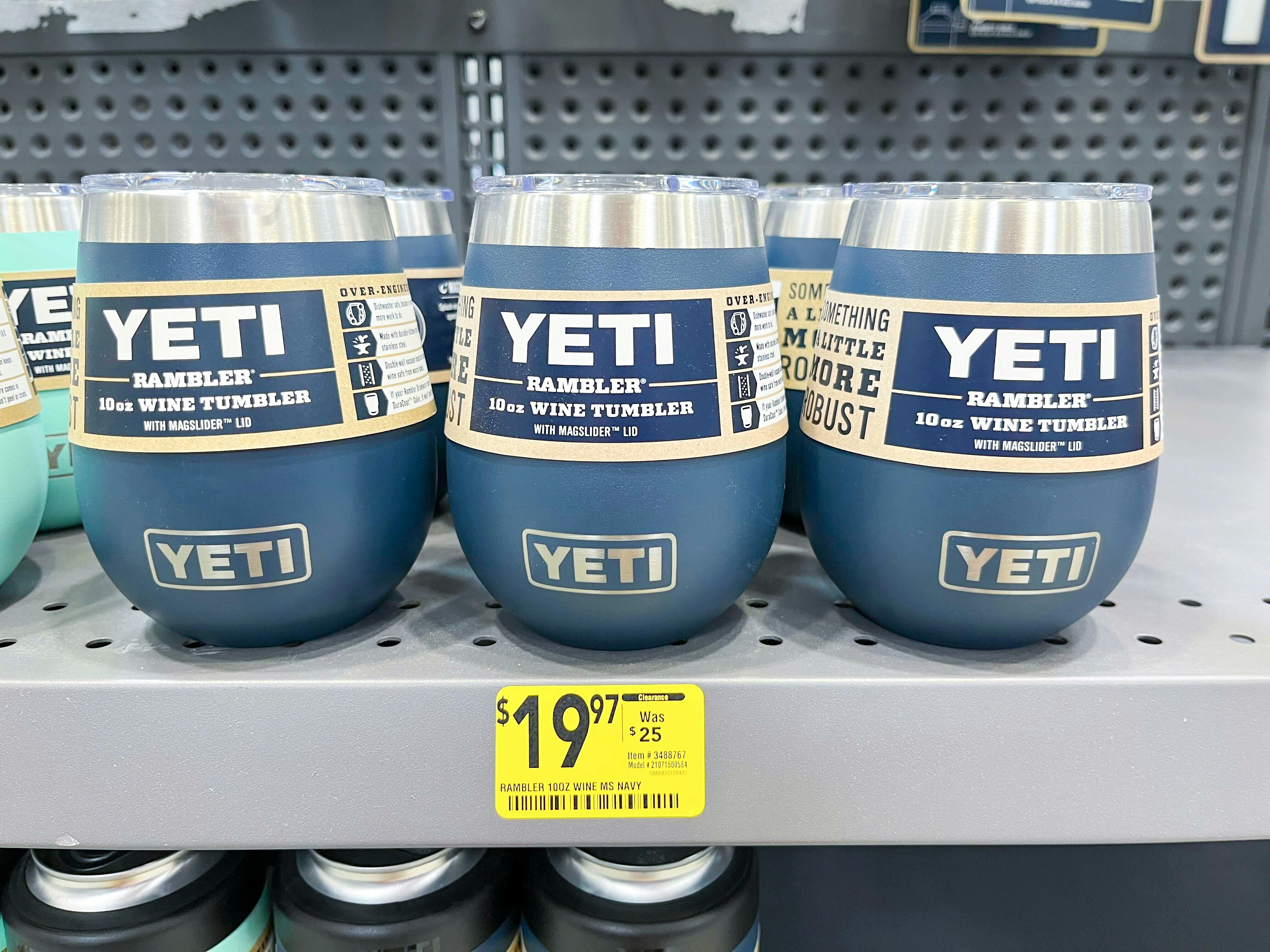 Three navy yeti 10 oz wine tumblers on the shelf at Lowe's, with a $19.97 sale price tag on the shelf