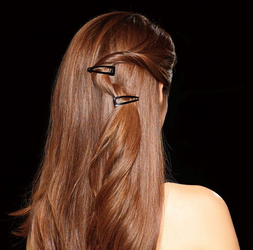 A woman with Revlon double grip hair clips in her hair.