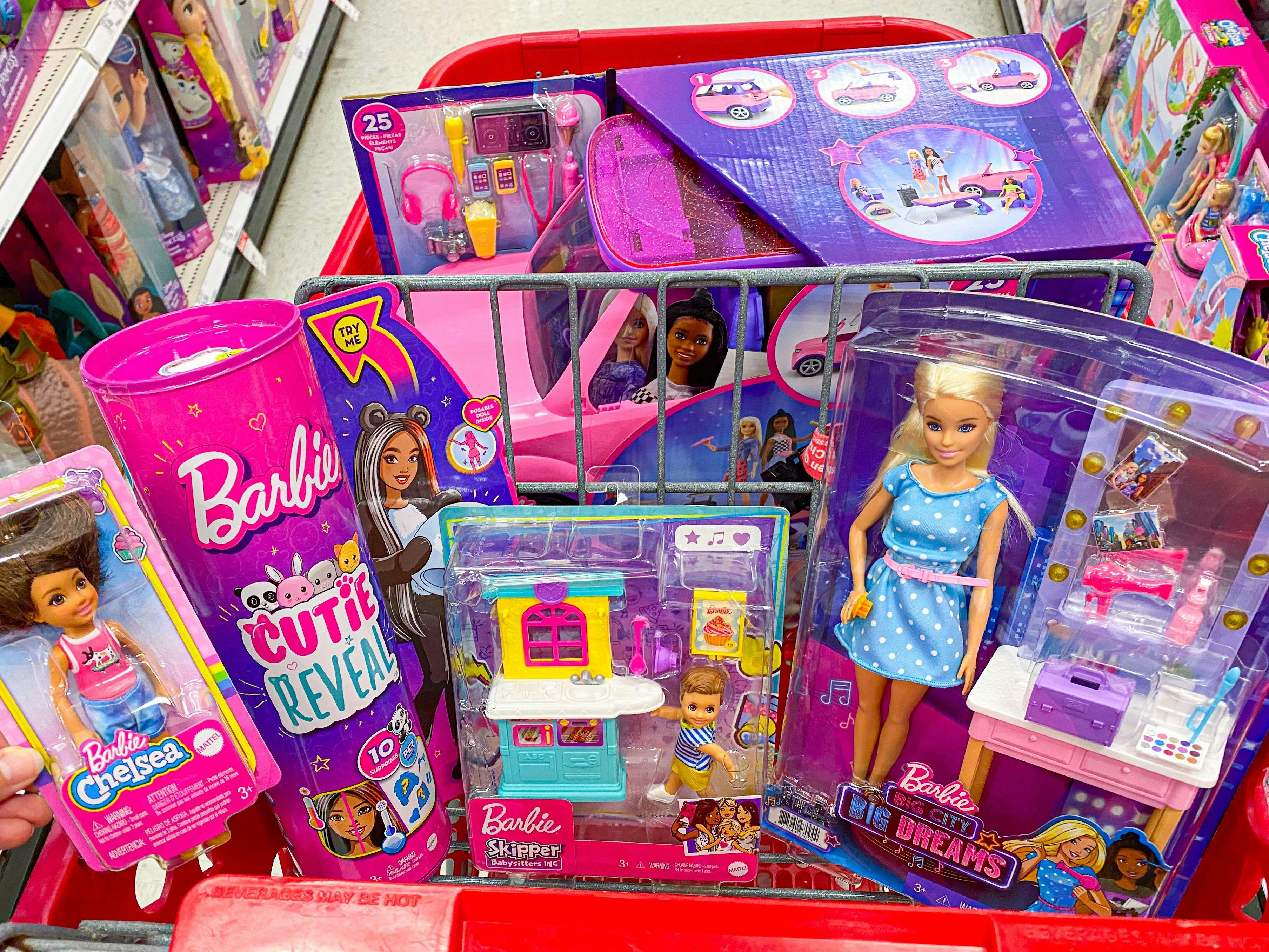 A Target shopping cart basket filled with Barbie toys.
