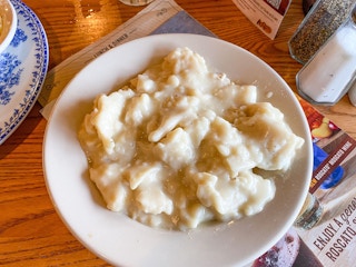 A plate of Cracker Barrel's Chicken n' Dumplings served on a table.
