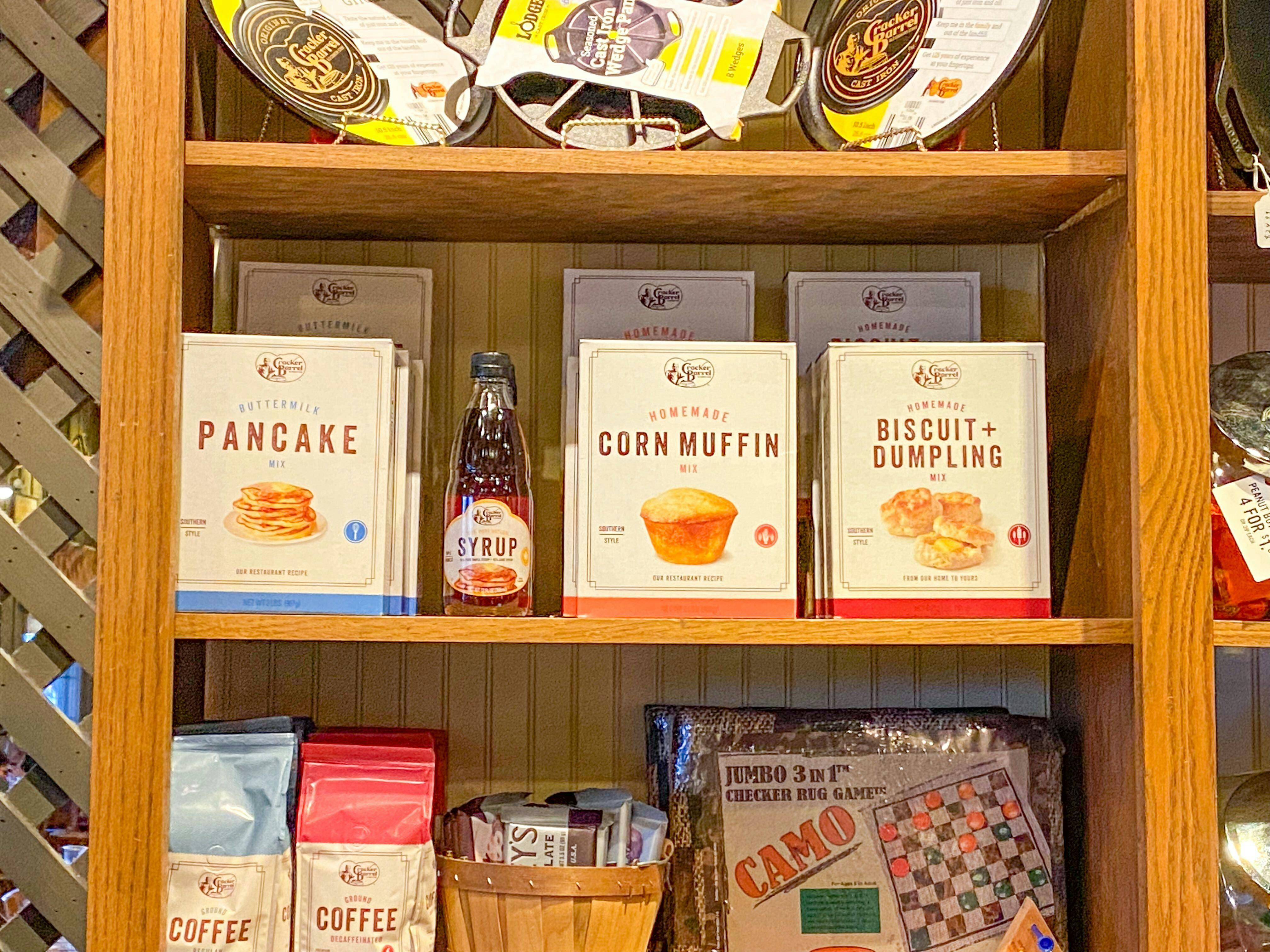 A shelf inside Cracker Barrel where boxes of pancake mix and other purchasable products are stocked.