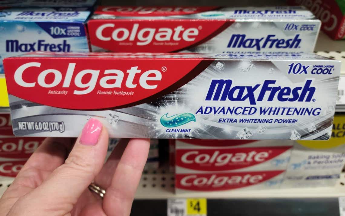 hand holding a colgate toothpaste