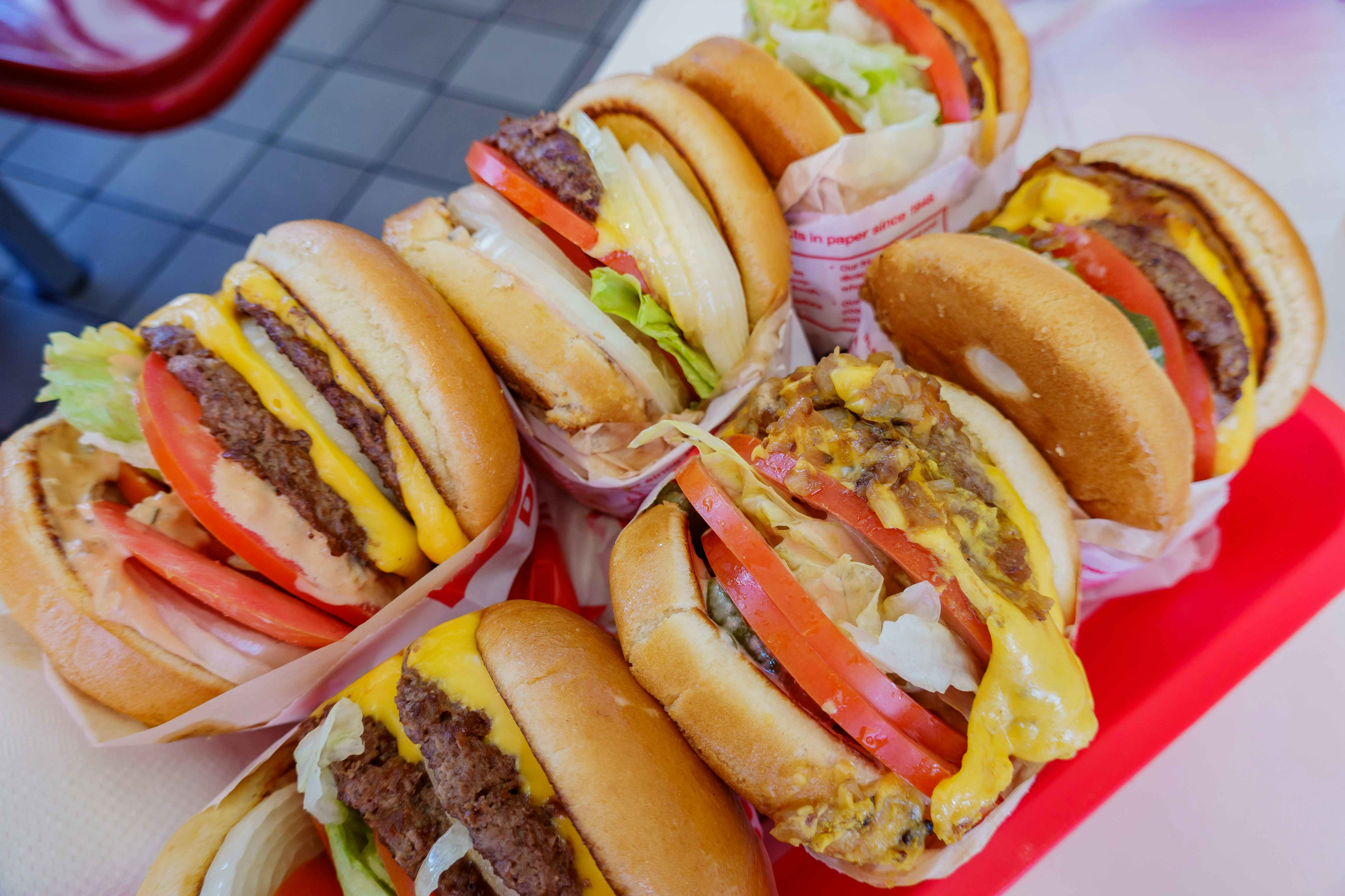 A tray with six In-N-Out burgers on it.