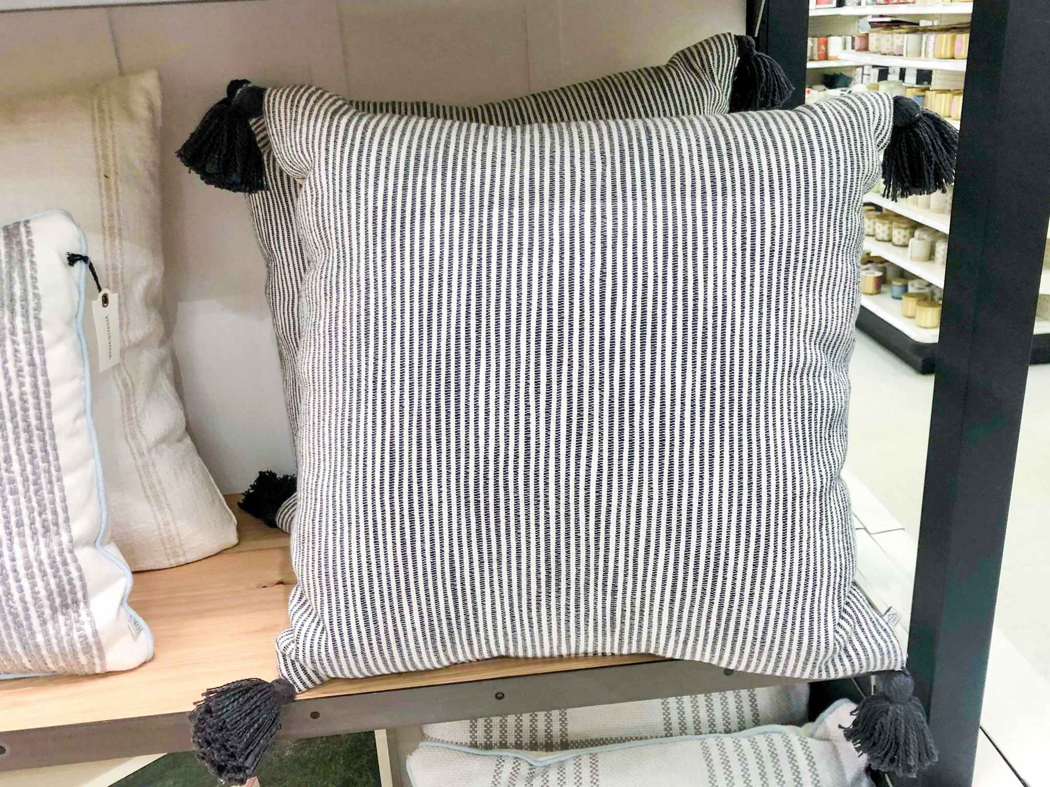 A black and white striped pillow on the shelf inside target