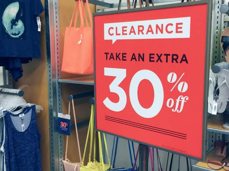 A clearance sign inside Old Navy that reads, "Clearance. Take an extra, 30% off