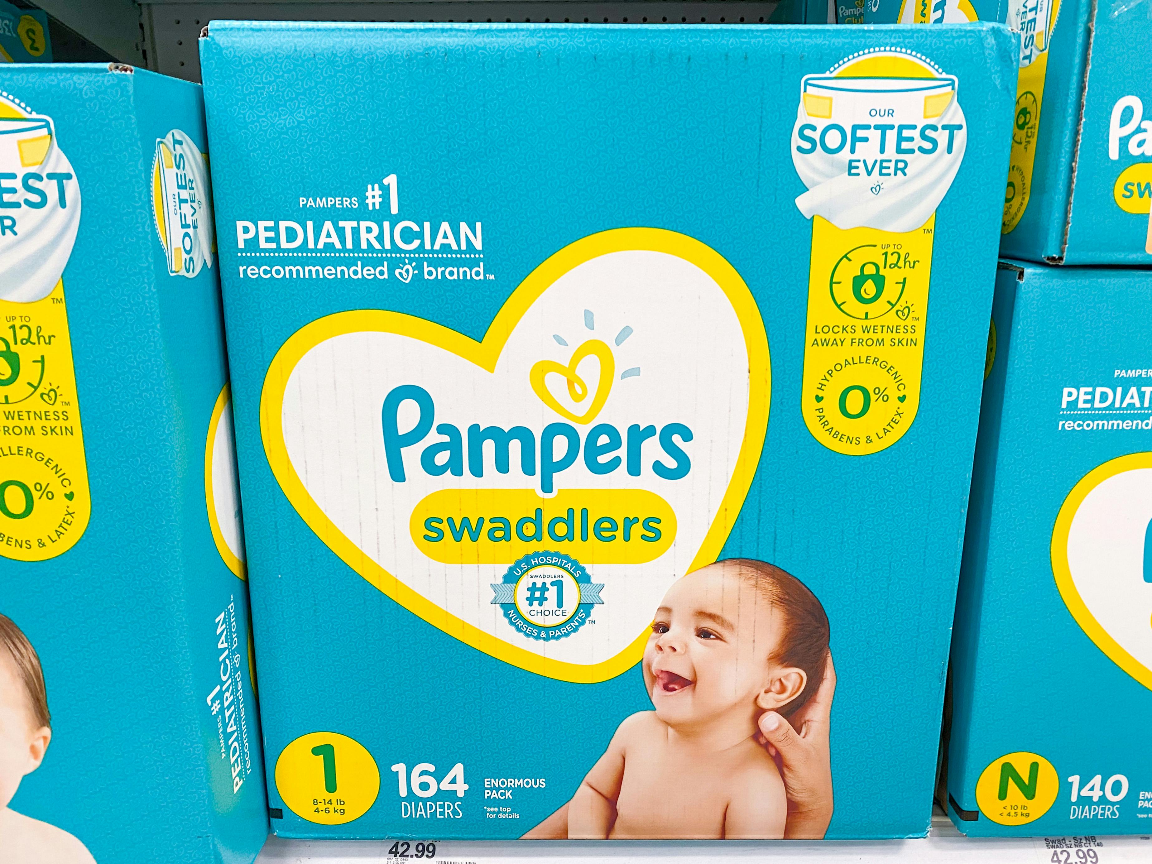 A box of Pampers Swaddlers diapers stocked on a shelf in the diaper aisle at Target.