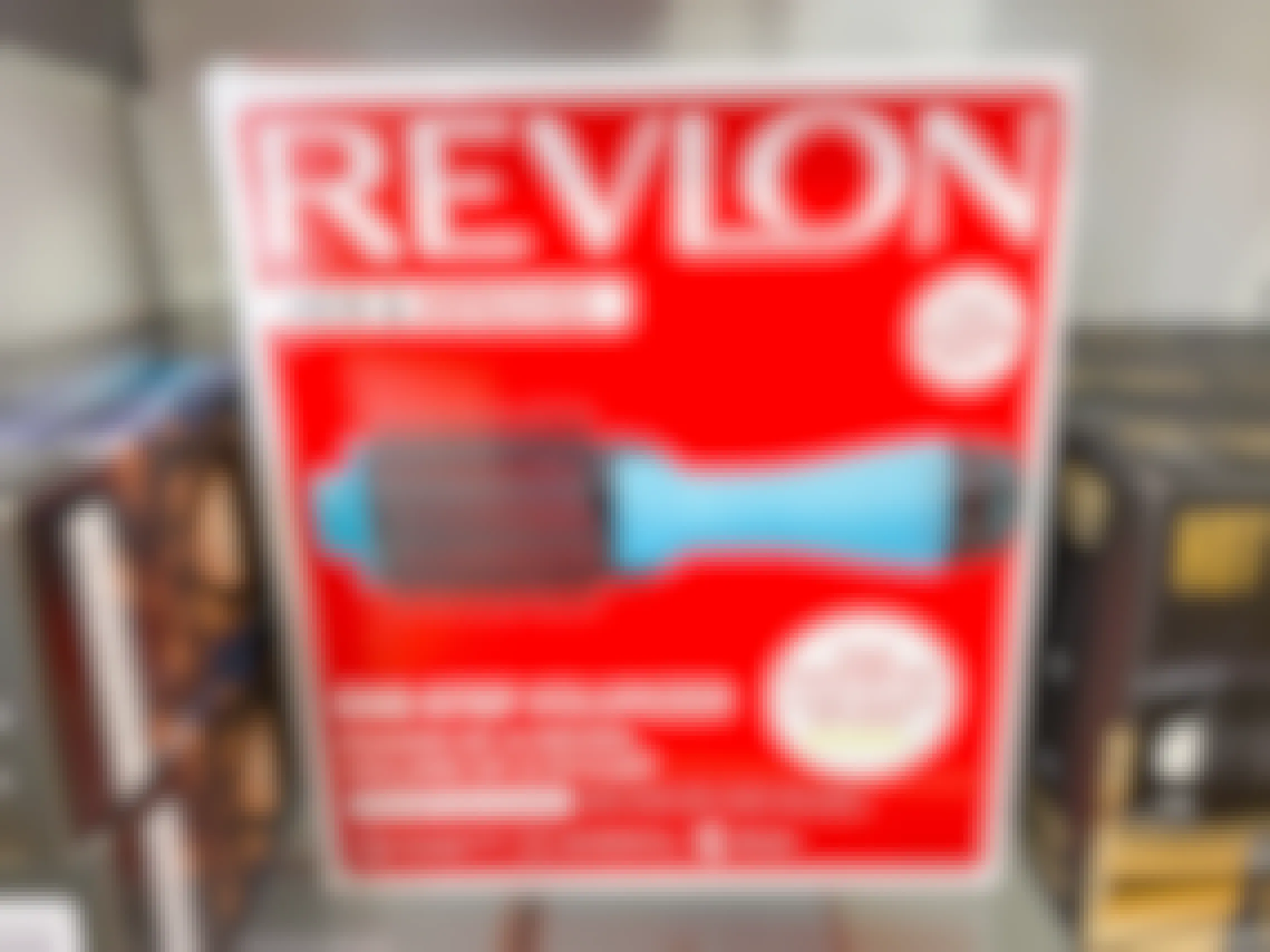 A Revlon One-Step Hot Air Brush in its box on a shelf.