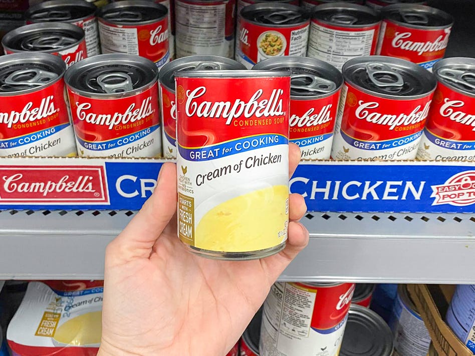 Someone holding a can of Campbell's chicken noodle soup in Walmart