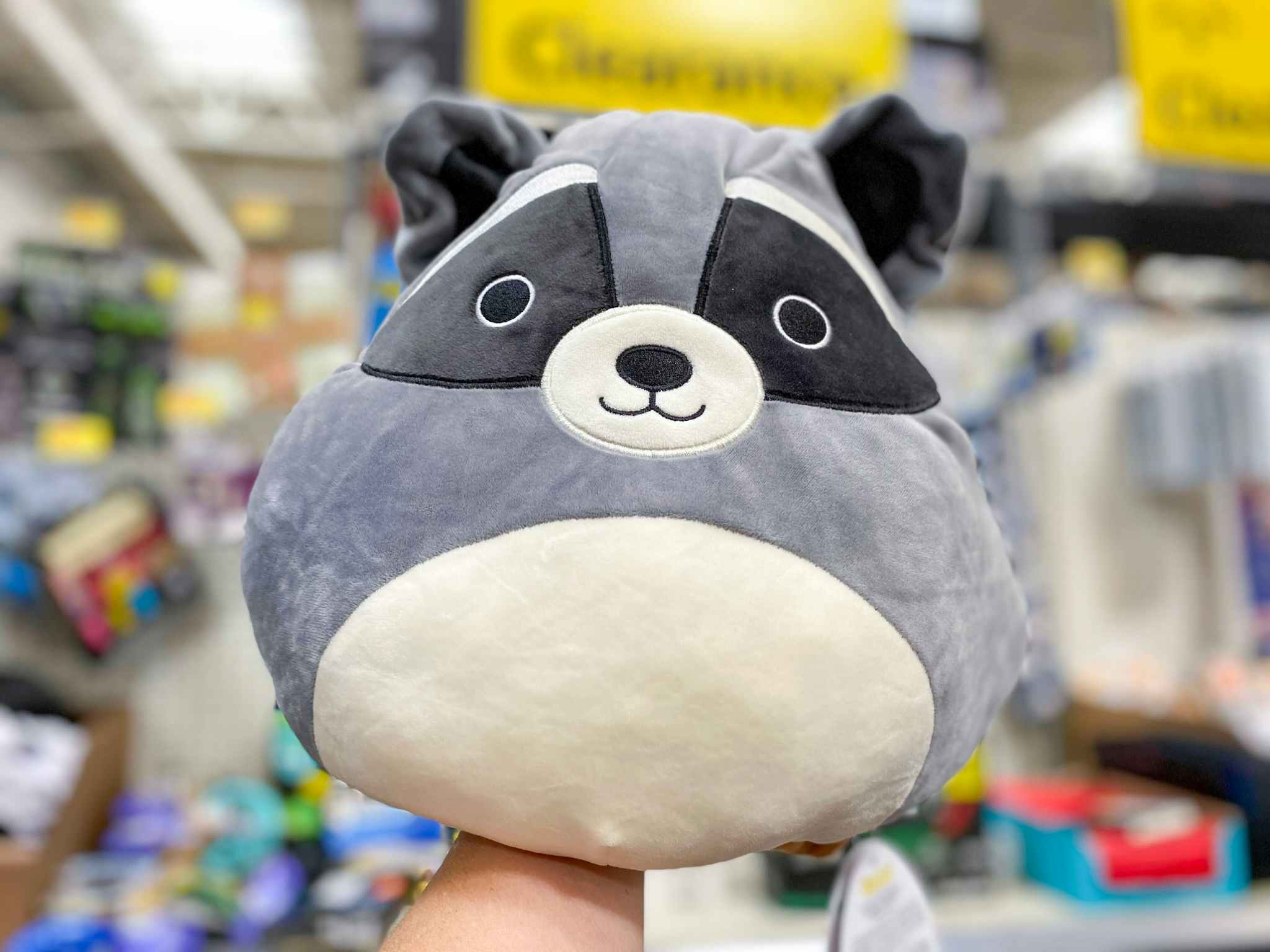 walmart squishmallows flip-a-mallow hand holding raccoon