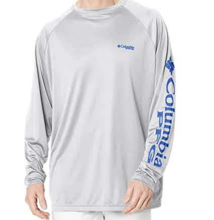 A guy modeling a grey t-shirt on a white background