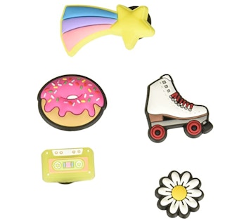 Five Croc charms on a white background