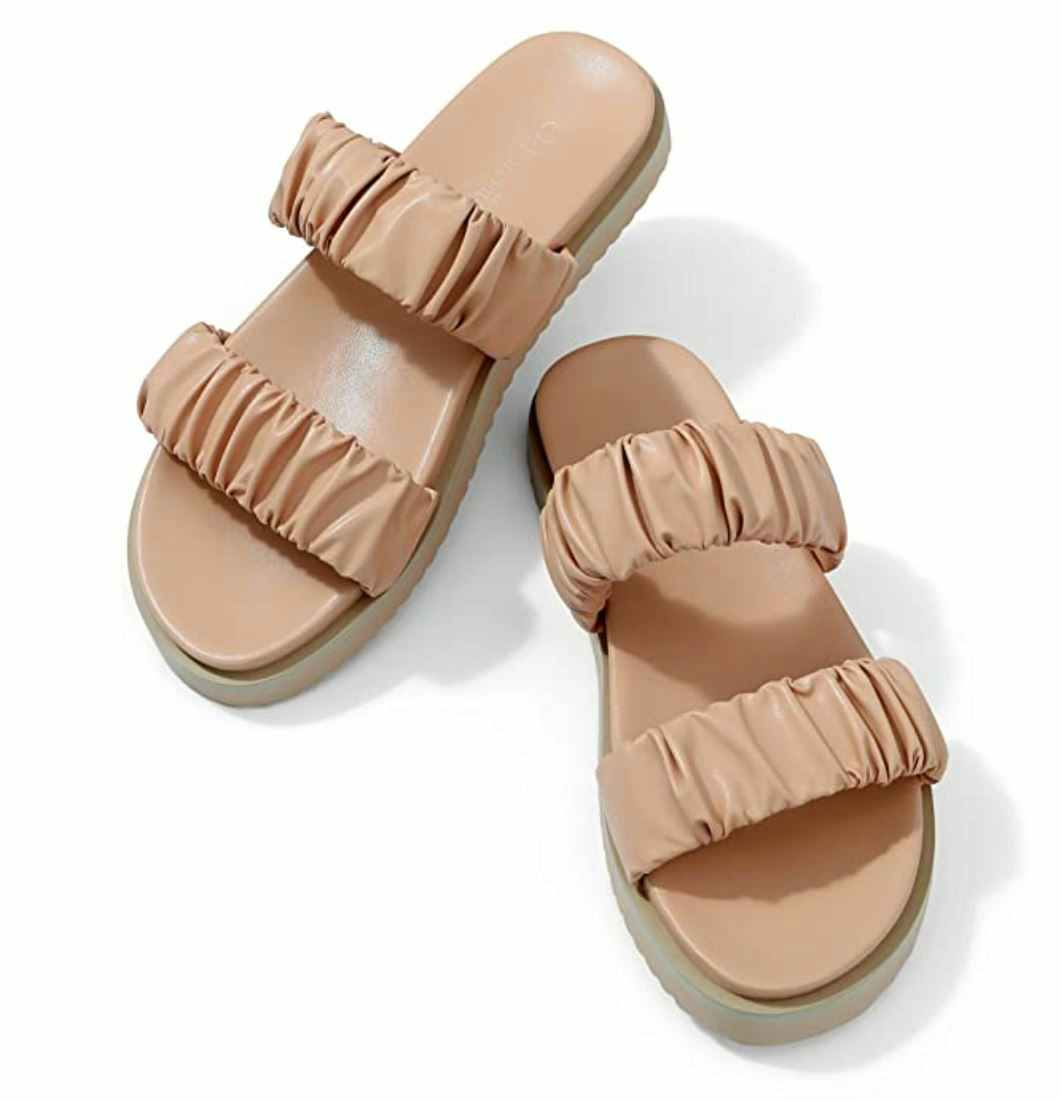 A pair of ruched slide sandals.