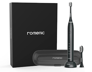 Black electric toothbrush with a case and replacement in front of a black box