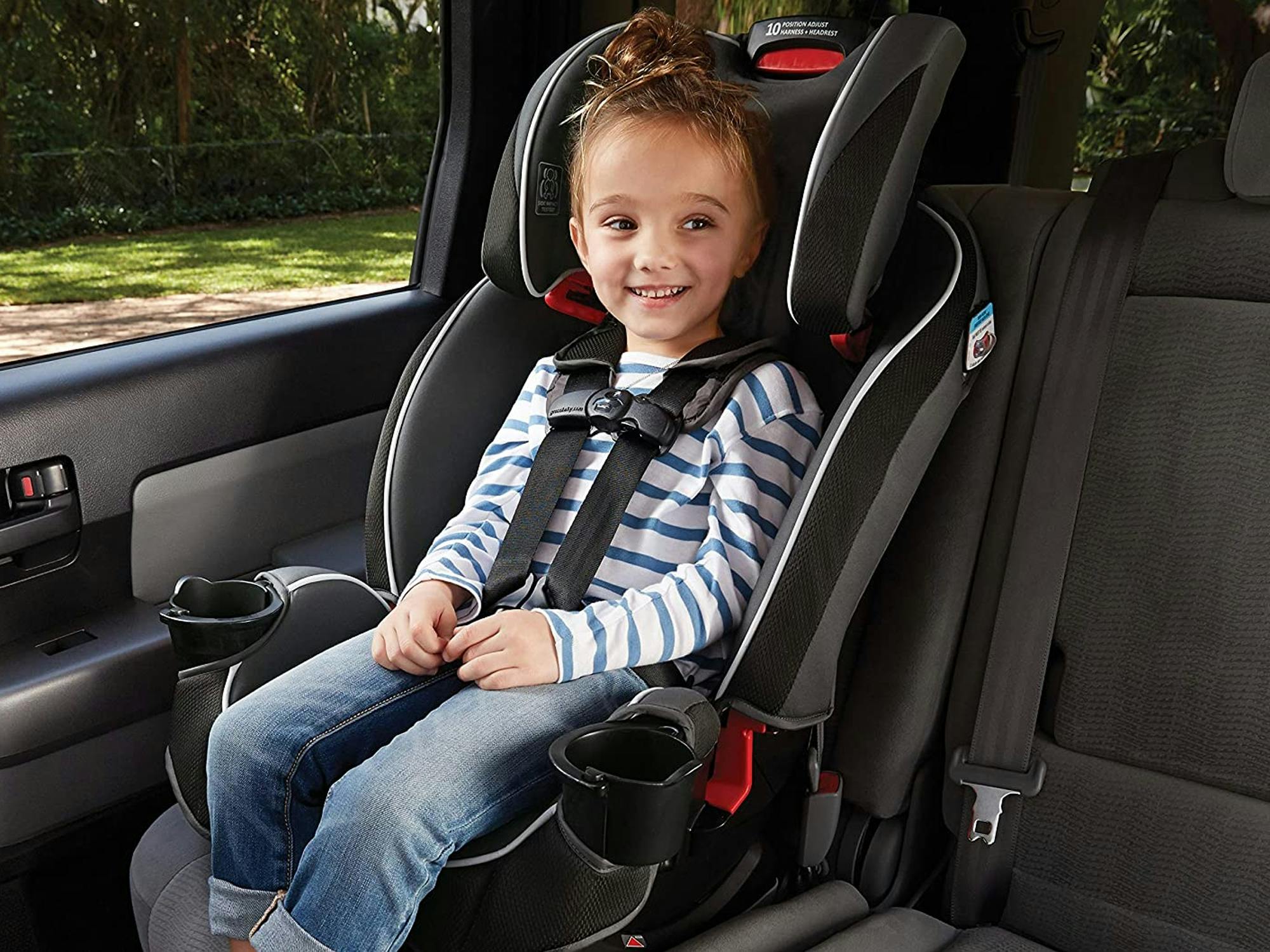 a child sitting in a graco slim fit car seat