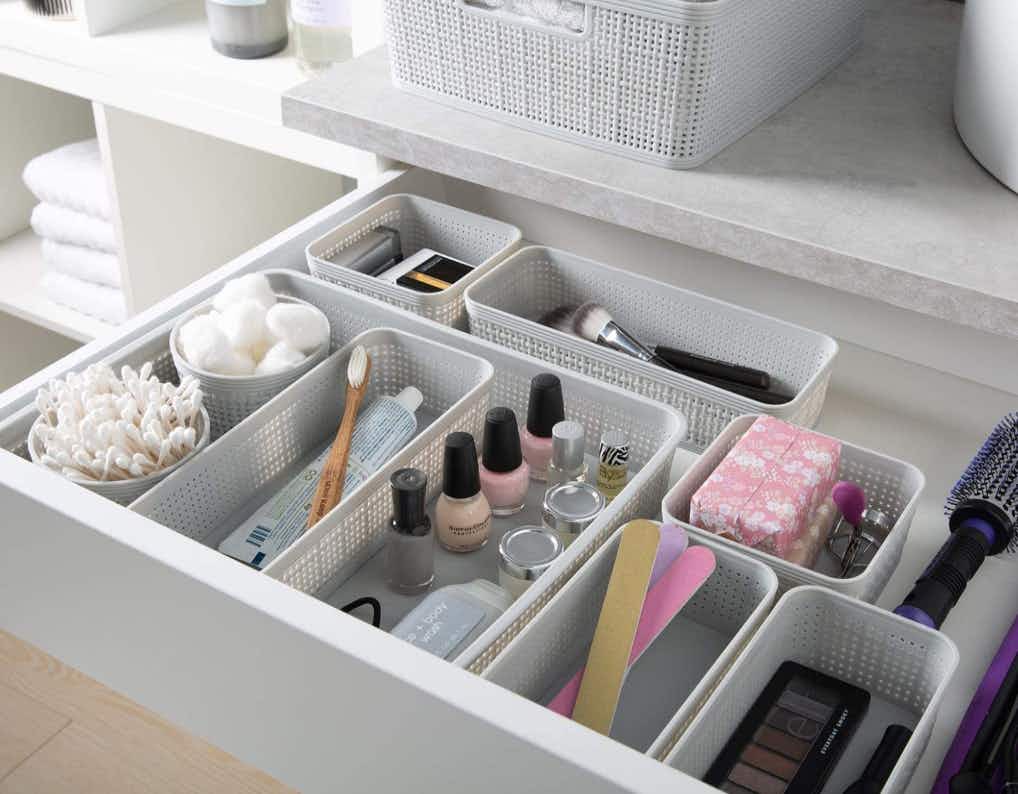 Bin in a open drawer filled with items